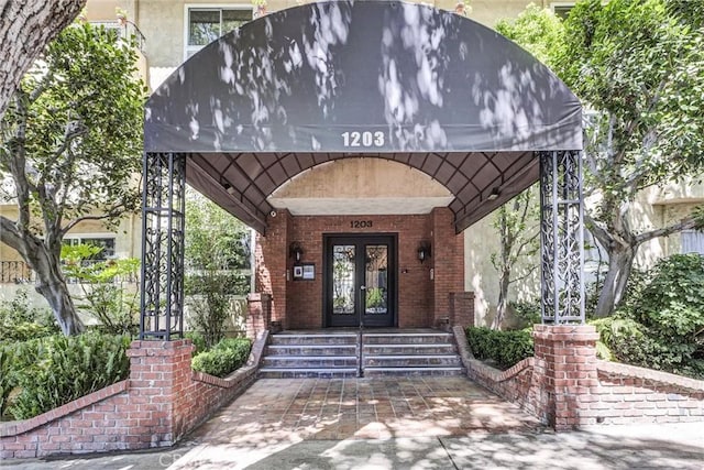1203 N Sweetzer Ave Unit 215, West Hollywood, CA 90069 - view of exterior entry featuring french doors and brick siding