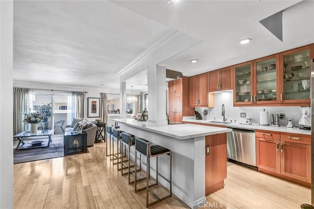 1203 N Sweetzer Ave Unit 215, West Hollywood, CA 90069 - kitchen featuring dishwasher, open floor plan, a kitchen breakfast bar, light countertops, and a center island