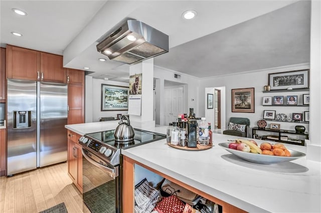 1203 N Sweetzer Ave Unit 215, West Hollywood, CA 90069 - kitchen featuring stainless steel appliances, range hood, brown cabinetry, light wood-type flooring, and recessed lighting