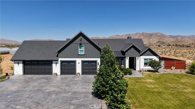 23670 Shirwaun, Apple Valley, CA 92307 - modern farmhouse style home with a front lawn, driveway, board and batten siding, a mountain view, and a standing seam roof