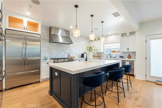 23670 Shirwaun, Apple Valley, CA 92307 - kitchen featuring stainless steel appliances, wall chimney range hood, decorative backsplash, white cabinets, and recessed lighting