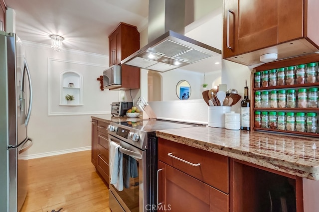 12200 Montecito Rd Unit C103, Seal Beach, CA 90740 - kitchen with appliances with stainless steel finishes, wall chimney exhaust hood, crown molding, light wood-style flooring, and brown cabinetry