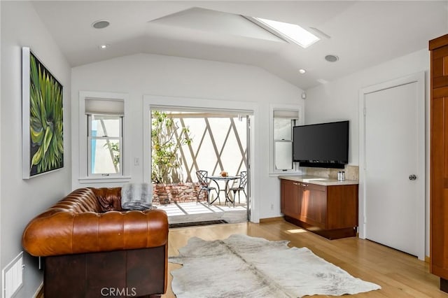 426 Nyes Pl, Laguna Beach, CA 92651 - living area with light wood finished floors, lofted ceiling, and recessed lighting