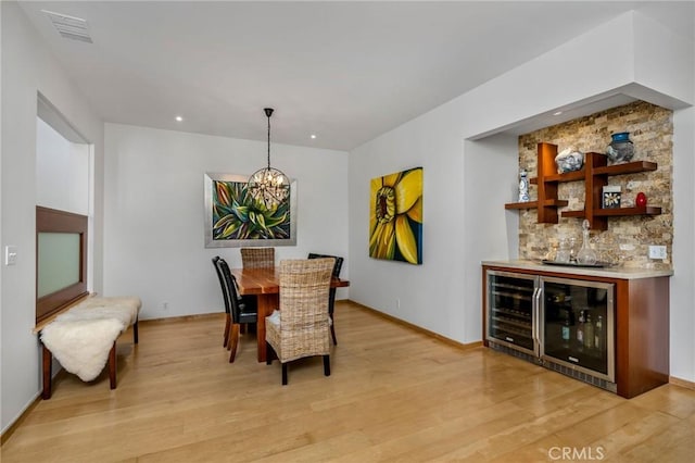 426 Nyes Pl, Laguna Beach, CA 92651 - dining room with a bar, a chandelier, beverage cooler, light wood-type flooring, and recessed lighting