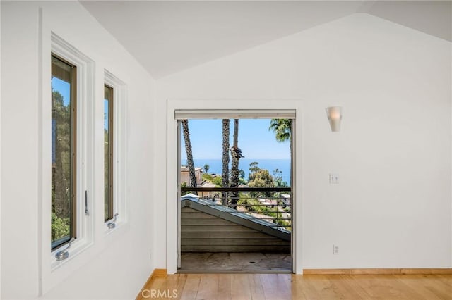 426 Nyes Pl, Laguna Beach, CA 92651 - doorway with lofted ceiling, a water view, and light wood-style flooring