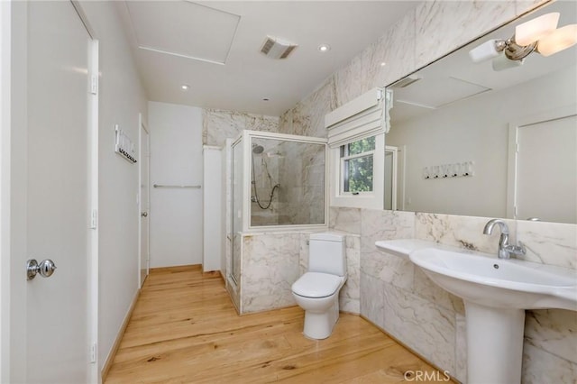 426 Nyes Pl, Laguna Beach, CA 92651 - bathroom featuring a marble finish shower and wood finished floors