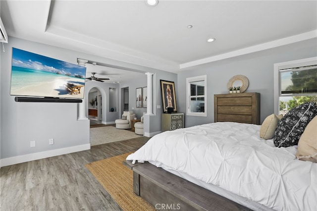 1 Tularosa Ct, Aliso Viejo, CA 92656 - bedroom featuring wood finished floors, recessed lighting, a raised ceiling, ornate columns, and arched walkways