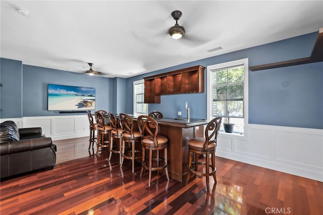 1 Tularosa Ct, Aliso Viejo, CA 92656 - indoor bar with a ceiling fan, a decorative wall, dark wood-style floors, and a wainscoted wall