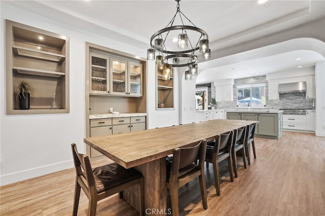 1 Tularosa Ct, Aliso Viejo, CA 92656 - dining area with a chandelier, light wood-style floors, recessed lighting, and arched walkways