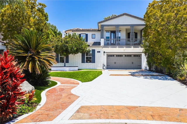 1 Tularosa Ct, Aliso Viejo, CA 92656 - view of front of house with an attached garage, driveway, a front lawn, brick siding, and stucco siding