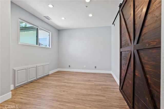 1 Tularosa Ct, Aliso Viejo, CA 92656 - empty room with light wood-style floors, recessed lighting, and a barn door