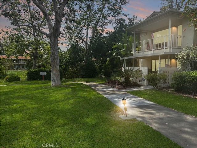 911 Ronda Sevilla Unit D, Laguna Woods, CA 92637 - view of green lawn with a balcony and driveway