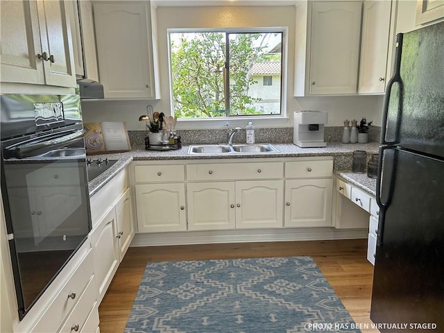 911 Ronda Sevilla Unit D, Laguna Woods, CA 92637 - kitchen featuring black appliances, dark wood-type flooring, and white cabinetry