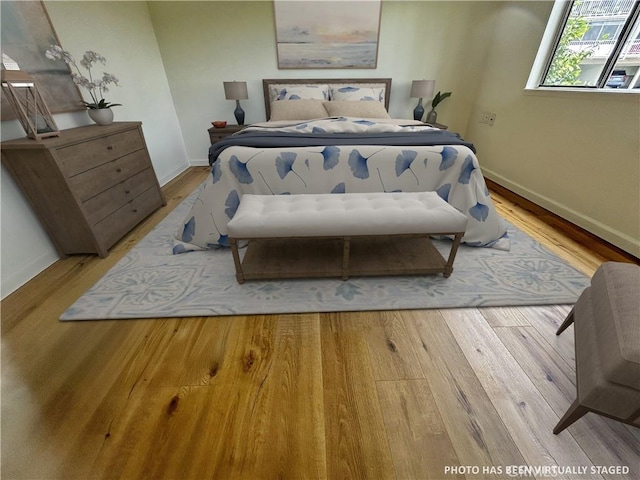 911 Ronda Sevilla Unit D, Laguna Woods, CA 92637 - bedroom featuring baseboards and wood finished floors
