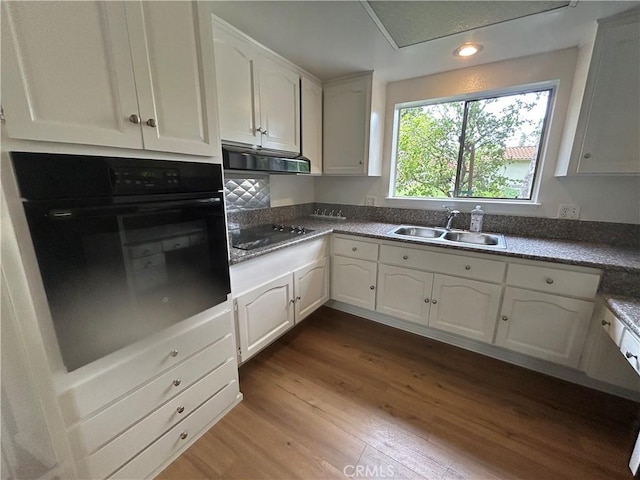 911 Ronda Sevilla Unit D, Laguna Woods, CA 92637 - kitchen featuring black appliances, dark wood-type flooring, under cabinet range hood, white cabinets, and recessed lighting