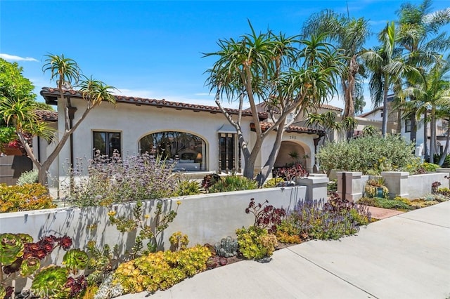 282 Argonne Ave, Long Beach, CA 90803 - view of front of home featuring a fenced front yard, stucco siding, and a tile roof