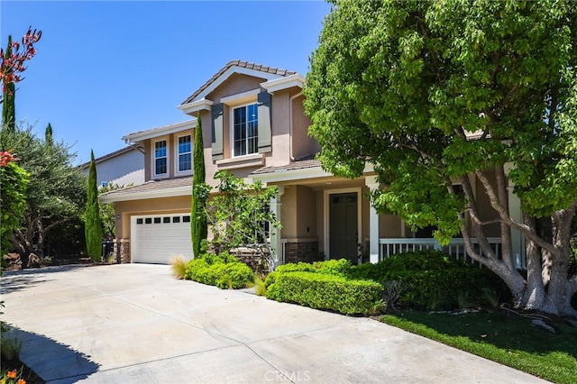 11 Heartwood Way, Aliso Viejo, CA 92656 - view of front of house featuring stucco siding, a garage, a tiled roof, driveway, and stone siding