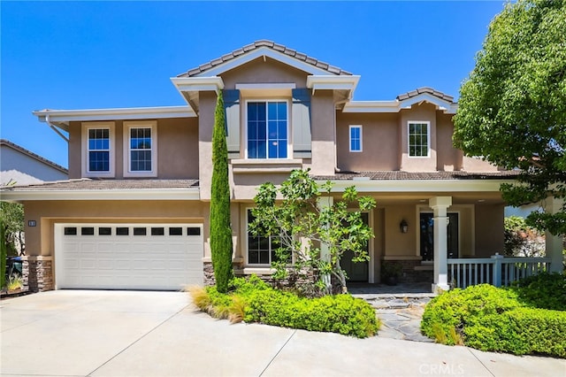 11 Heartwood Way, Aliso Viejo, CA 92656 - view of front facade featuring stucco siding, a tile roof, an attached garage, concrete driveway, and a porch