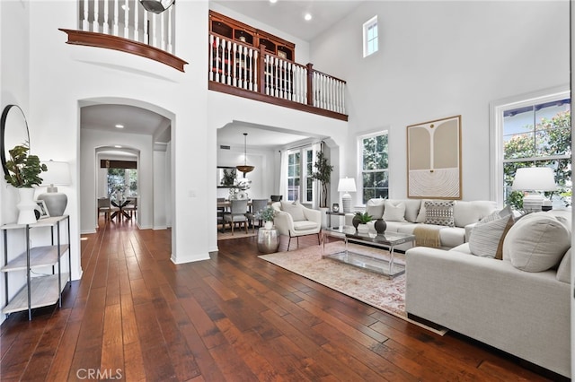 11 Heartwood Way, Aliso Viejo, CA 92656 - living area with arched walkways, healthy amount of natural light, dark wood-style flooring, a high ceiling, and recessed lighting