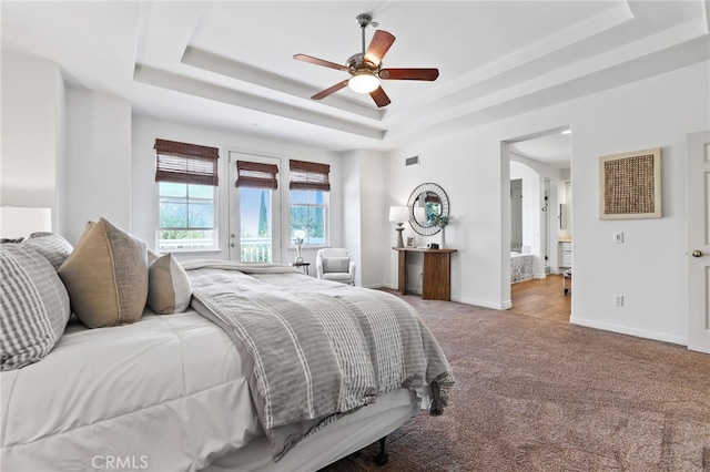 11 Heartwood Way, Aliso Viejo, CA 92656 - carpeted bedroom featuring a raised ceiling, ensuite bathroom, and a ceiling fan