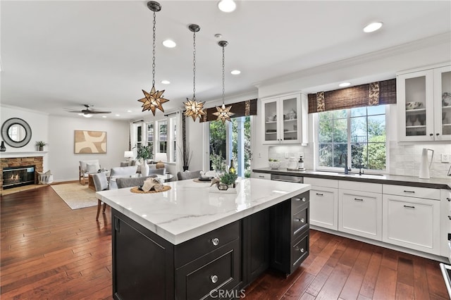 11 Heartwood Way, Aliso Viejo, CA 92656 - kitchen with dark cabinets, recessed lighting, crown molding, a center island, and white cabinets