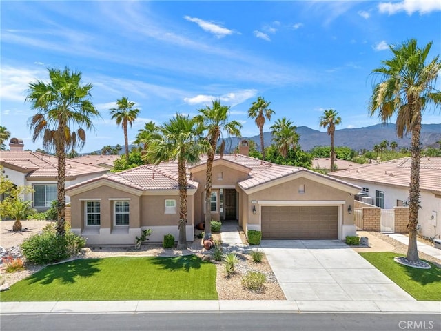 79787 Parkway Esplanade N, La Quinta, CA 92253 - view of front of property with stucco siding, a mountain view, a garage, driveway, and a tile roof