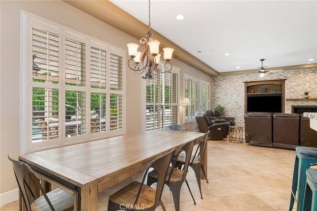 79787 Parkway Esplanade N, La Quinta, CA 92253 - dining room with a chandelier, light tile patterned floors, recessed lighting, and a fireplace