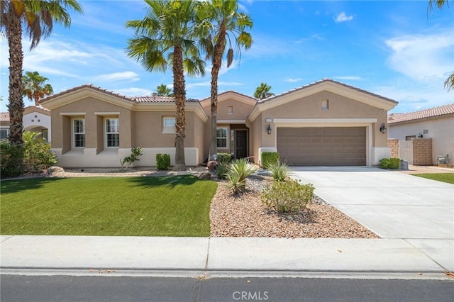79787 Parkway Esplanade N, La Quinta, CA 92253 - view of front of home with stucco siding, a garage, a front lawn, driveway, and a tiled roof