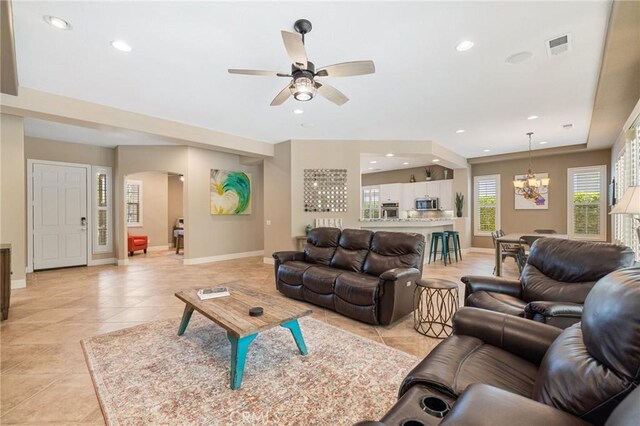 79787 Parkway Esplanade N, La Quinta, CA 92253 - living room with arched walkways, a ceiling fan, recessed lighting, light tile patterned flooring, and a chandelier