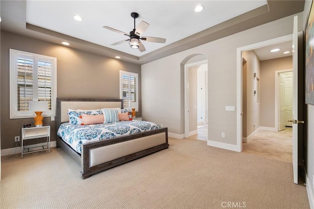 79787 Parkway Esplanade N, La Quinta, CA 92253 - bedroom with light carpet, recessed lighting, multiple windows, arched walkways, and a raised ceiling