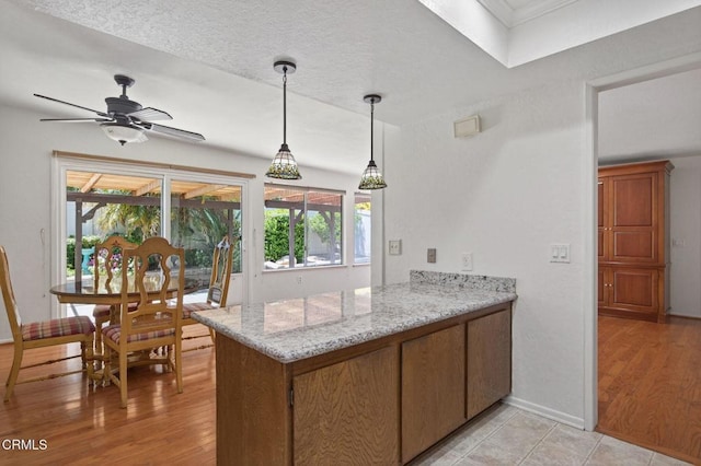 27127 Rio Bosque Dr, Valencia, CA 91354 - kitchen with a peninsula, plenty of natural light, and light wood-style flooring