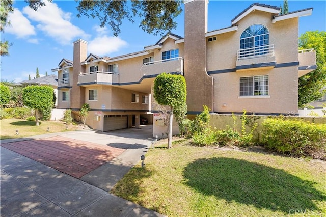150 Diamond St Unit B, Arcadia, CA 91006 - view of front facade featuring a chimney, concrete driveway, stucco siding, and an attached garage