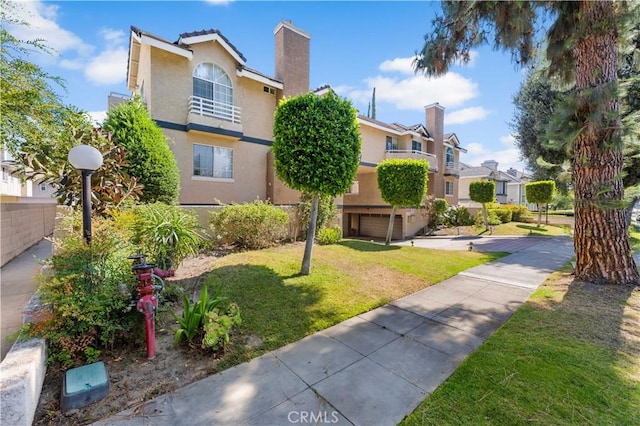 150 Diamond St Unit B, Arcadia, CA 91006 - view of front facade with stucco siding, a front yard, a residential view, and a chimney