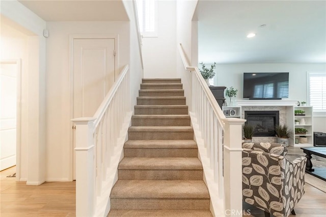 1827 Montecito Ln, Redlands, CA 92374 - stairs featuring a glass covered fireplace, wood finished floors, and recessed lighting