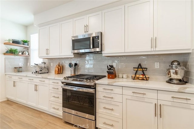 1827 Montecito Ln, Redlands, CA 92374 - kitchen featuring appliances with stainless steel finishes, open shelves, decorative backsplash, and white cabinets