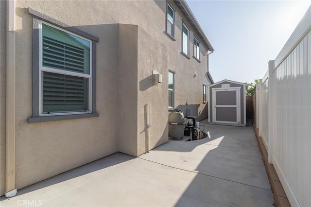 1827 Montecito Ln, Redlands, CA 92374 - view of property exterior with stucco siding, a storage shed, and a patio