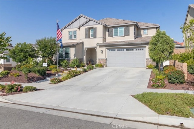1827 Montecito Ln, Redlands, CA 92374 - view of front facade featuring stucco siding, driveway, stone siding, and a garage