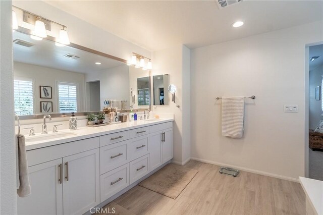 1827 Montecito Ln, Redlands, CA 92374 - full bath featuring wood finished floors, double vanity, and recessed lighting