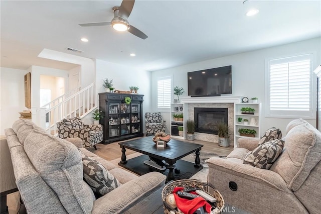 1827 Montecito Ln, Redlands, CA 92374 - living room with wood finished floors, a ceiling fan, a glass covered fireplace, stairs, and recessed lighting