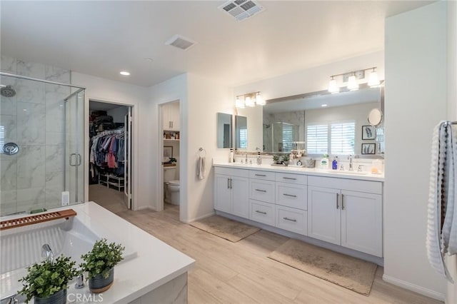 1827 Montecito Ln, Redlands, CA 92374 - full bathroom with a stall shower, double vanity, wood finished floors, a tub to relax in, and a walk in closet