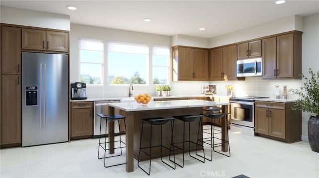 22325 Sage Ct, Torrance, CA 90502 - kitchen featuring stainless steel appliances, a kitchen island, tasteful backsplash, a breakfast bar, and recessed lighting