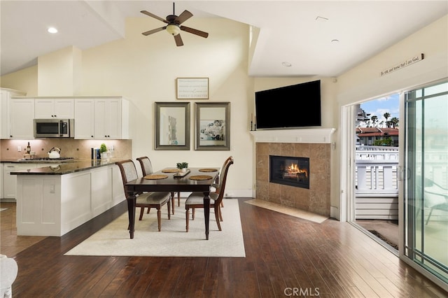 806 N Irena Ave Unit A, Redondo Beach, CA 90277 - dining room with dark wood-type flooring, ceiling fan, a fireplace, high vaulted ceiling, and recessed lighting