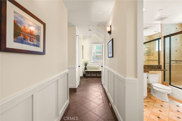 806 N Irena Ave Unit A, Redondo Beach, CA 90277 - corridor with wainscoting, tile patterned floors, and a decorative wall