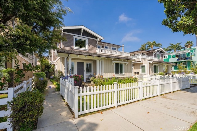 806 N Irena Ave Unit A, Redondo Beach, CA 90277 - view of front of property with a fenced front yard, board and batten siding, and a balcony