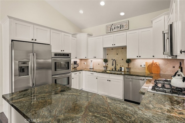 806 N Irena Ave Unit A, Redondo Beach, CA 90277 - kitchen with appliances with stainless steel finishes, white cabinetry, vaulted ceiling, tasteful backsplash, and recessed lighting