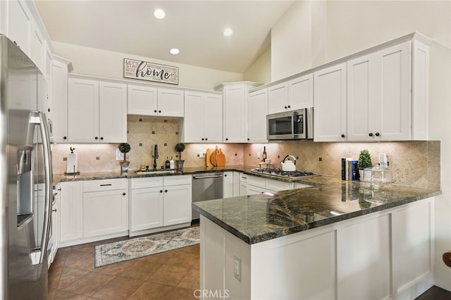 806 N Irena Ave Unit A, Redondo Beach, CA 90277 - kitchen featuring appliances with stainless steel finishes, a peninsula, white cabinets, decorative backsplash, and recessed lighting