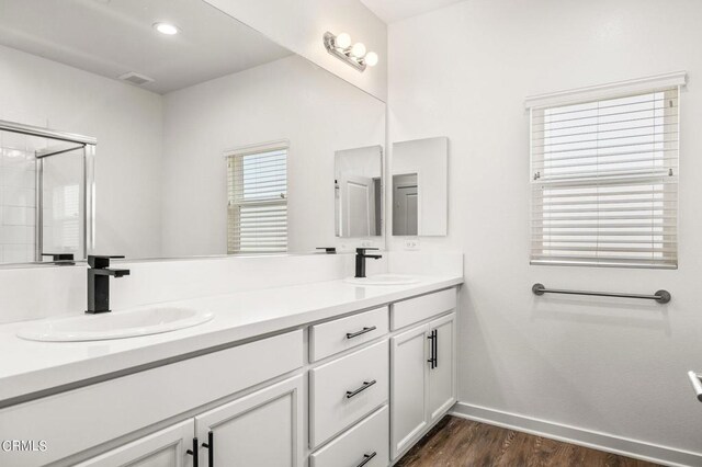 307 N F St Unit 201, Oxnard, CA 93030 - bathroom with double vanity, wood finished floors, and an enclosed shower