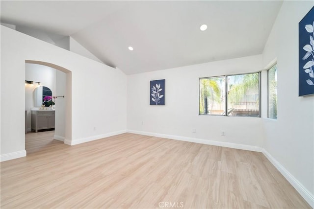 23760 Timber Bluff Ct, Moreno Valley, CA 92557 - unfurnished room featuring arched walkways, light wood-type flooring, vaulted ceiling, and recessed lighting