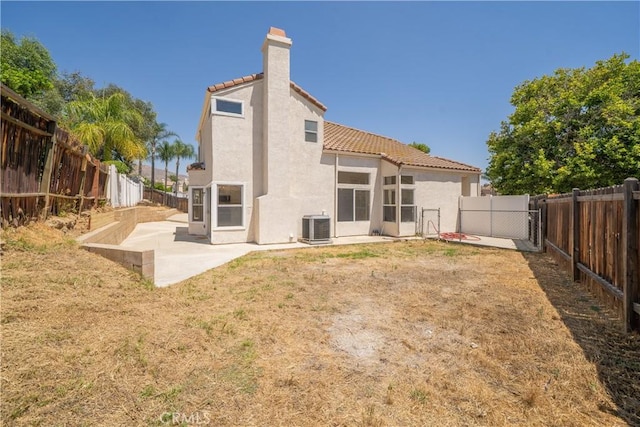 23760 Timber Bluff Ct, Moreno Valley, CA 92557 - rear view of house with a tile roof, a patio, stucco siding, and a fenced backyard