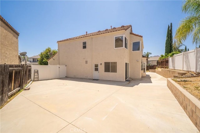 23760 Timber Bluff Ct, Moreno Valley, CA 92557 - rear view of house featuring stucco siding, a fenced backyard, and a patio area